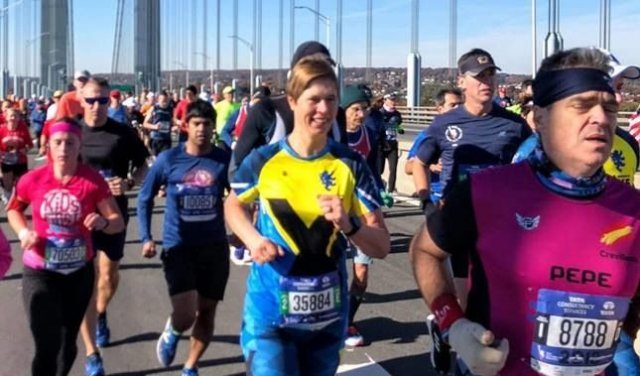 Президентът на Естония Керсти Калюлайд (в жълто и синьо) се включи в маратона в Ню Йорк под наблюдението на двама агенти по сигурността